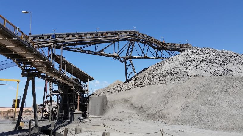 A fixed conveyor stacker collapsed onto its stockpile after structural failure from corrosion.